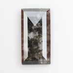 Rectangular step cut lab grown diamond featuring bold black salt and pepper inclusions with mirror-like facets and a modern geometric shape