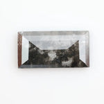 Rectangular step cut lab grown diamond featuring bold black salt and pepper inclusions with mirror-like facets and a modern geometric shape