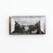 Rectangular step cut lab grown diamond featuring bold black salt and pepper inclusions with mirror-like facets and a modern geometric shape