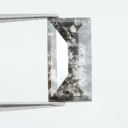 Rectangular step cut lab grown diamond featuring bold black salt and pepper inclusions with mirror-like facets and a modern geometric shape