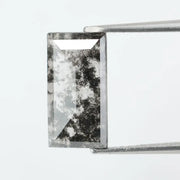 Rectangular step cut lab grown diamond featuring bold black salt and pepper inclusions with mirror-like facets and a modern geometric shape