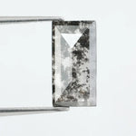 Rectangular step cut lab grown diamond featuring bold black salt and pepper inclusions with mirror-like facets and a modern geometric shape
