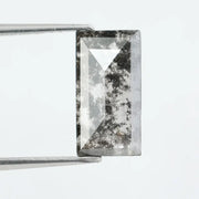 Rectangular step cut lab grown diamond featuring bold black salt and pepper inclusions with mirror-like facets and a modern geometric shape