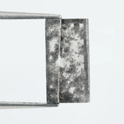 Rectangular step cut lab grown diamond featuring bold black salt and pepper inclusions with mirror-like facets and a modern geometric shape