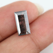 Rectangular step cut lab grown diamond featuring bold black salt and pepper inclusions with mirror-like facets and a modern geometric shape