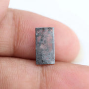 Rectangular step cut lab grown diamond featuring bold black salt and pepper inclusions with mirror-like facets and a modern geometric shape