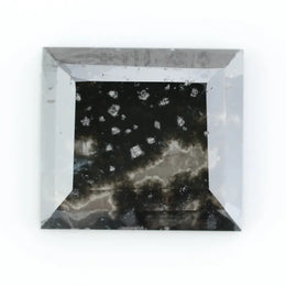 Rectangular step cut salt and pepper lab grown diamond with black galaxy inclusions and scattered white speckles, unique ethical diamond for custom jewelry design