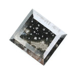 Rectangular step cut salt and pepper lab grown diamond with black galaxy inclusions and scattered white speckles, unique ethical diamond for custom jewelry design