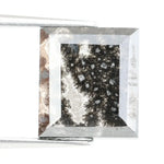 Rectangular step cut salt and pepper lab grown diamond with black galaxy inclusions and scattered white speckles, unique ethical diamond for custom jewelry design