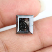Rectangular step cut salt and pepper lab grown diamond with black galaxy inclusions and scattered white speckles, unique ethical diamond for custom jewelry design