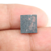 Rectangular step cut salt and pepper lab grown diamond with black galaxy inclusions and scattered white speckles, unique ethical diamond for custom jewelry design