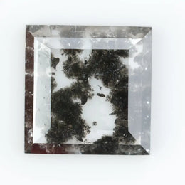 Geometric step cut lab grown salt and pepper diamond with black moss-like inclusions, clear edges and modern faceting, unique ethical loose diamond for alternative engagement ring