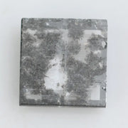 Geometric step cut lab grown salt and pepper diamond with black moss-like inclusions, clear edges and modern faceting, unique ethical loose diamond for alternative engagement ring
