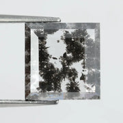 Geometric step cut lab grown salt and pepper diamond with black moss-like inclusions, clear edges and modern faceting, unique ethical loose diamond for alternative engagement ring