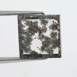 Geometric step cut lab grown salt and pepper diamond with black moss-like inclusions, clear edges and modern faceting, unique ethical loose diamond for alternative engagement ring