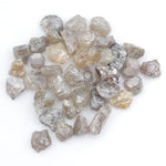 assorted uncut natural diamonds in varied colors for bespoke engagement ring settings and jewelry designs