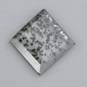 Square step-cut lab grown diamond with dramatic black salt and pepper inclusions, showcasing a unique geometric faceted structure and modern ethical gemstone design