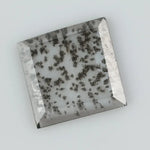 Square step-cut lab grown diamond with dramatic black salt and pepper inclusions, showcasing a unique geometric faceted structure and modern ethical gemstone design