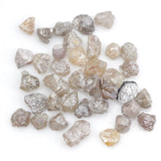 assorted uncut natural diamonds in varied colors for bespoke engagement ring settings and jewelry designs