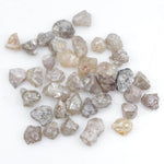 assorted uncut natural diamonds in varied colors for bespoke engagement ring settings and jewelry designs