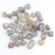 assorted uncut natural diamonds in varied colors for bespoke engagement ring settings and jewelry designs