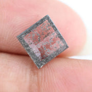 Square step-cut lab grown diamond with dramatic black salt and pepper inclusions, showcasing a unique geometric faceted structure and modern ethical gemstone design