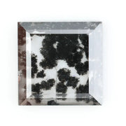 Close-up of a lab-grown diamond featuring unique black inclusions, showcasing exceptional clarity and brilliance, perfect for an elegant jewelry piece.