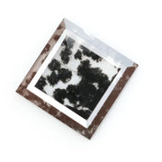 Close-up of a lab-grown diamond featuring unique black inclusions, showcasing exceptional clarity and brilliance, perfect for an elegant jewelry piece.