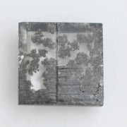 Close-up of a lab-grown diamond featuring unique black inclusions, showcasing exceptional clarity and brilliance, perfect for an elegant jewelry piece.