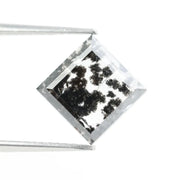 Close-up of a lab-grown diamond featuring unique black inclusions, showcasing exceptional clarity and brilliance, perfect for an elegant jewelry piece.