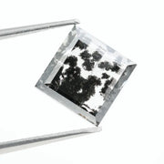 Close-up of a lab-grown diamond featuring unique black inclusions, showcasing exceptional clarity and brilliance, perfect for an elegant jewelry piece.