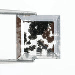 Close-up of a lab-grown diamond featuring unique black inclusions, showcasing exceptional clarity and brilliance, perfect for an elegant jewelry piece.