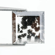 Close-up of a lab-grown diamond featuring unique black inclusions, showcasing exceptional clarity and brilliance, perfect for an elegant jewelry piece.