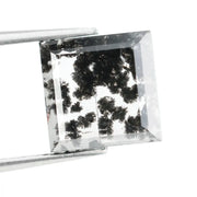 Close-up of a lab-grown diamond featuring unique black inclusions, showcasing exceptional clarity and brilliance, perfect for an elegant jewelry piece.