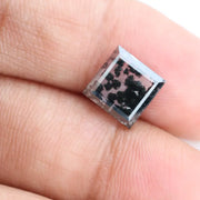 Close-up of a lab-grown diamond featuring unique black inclusions, showcasing exceptional clarity and brilliance, perfect for an elegant jewelry piece.