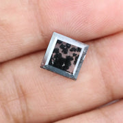 Close-up of a lab-grown diamond featuring unique black inclusions, showcasing exceptional clarity and brilliance, perfect for an elegant jewelry piece.