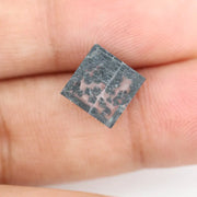 Close-up of a lab-grown diamond featuring unique black inclusions, showcasing exceptional clarity and brilliance, perfect for an elegant jewelry piece.