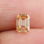 0.53 Ct fancy brown emerald cut lab grown diamond with elegant step cut facets, premium loose diamond for custom jewelry designs.