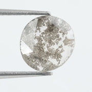 Round lab-grown diamond with unique gray inclusions, faceted for maximum sparkle, ethically created, ideal for custom rings and jewelry