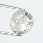 Round lab-grown diamond with unique gray inclusions, faceted for maximum sparkle, ethically created, ideal for custom rings and jewelry