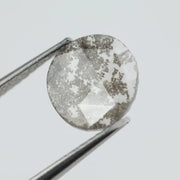 Round lab-grown diamond with unique gray inclusions, faceted for maximum sparkle, ethically created, ideal for custom rings and jewelry