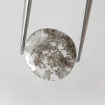 Round lab-grown diamond with unique gray inclusions, faceted for maximum sparkle, ethically created, ideal for custom rings and jewelry