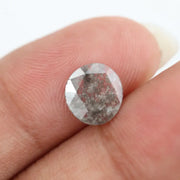 Round lab-grown diamond with unique gray inclusions, faceted for maximum sparkle, ethically created, ideal for custom rings and jewelry