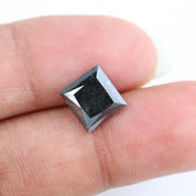 Close-up of a square princess cut black lab-grown diamond with precise facets, reflecting light, showcasing ethical and sustainable luxury gemstone quality.
