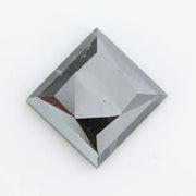 Close-up of a square princess cut black lab-grown diamond with precise facets, reflecting light, showcasing ethical and sustainable luxury gemstone quality.