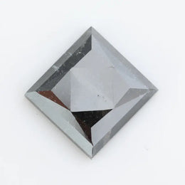 Close-up of a square princess cut black lab-grown diamond with precise facets, reflecting light, showcasing ethical and sustainable luxury gemstone quality.