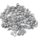 grey black natural diamond with a rugged raw surface and uncut profile
