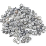 grey black natural diamond with a rugged raw surface and uncut profile