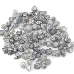 grey black natural diamond with a rugged raw surface and uncut profile