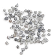 grey black natural diamond with a rugged raw surface and uncut profile